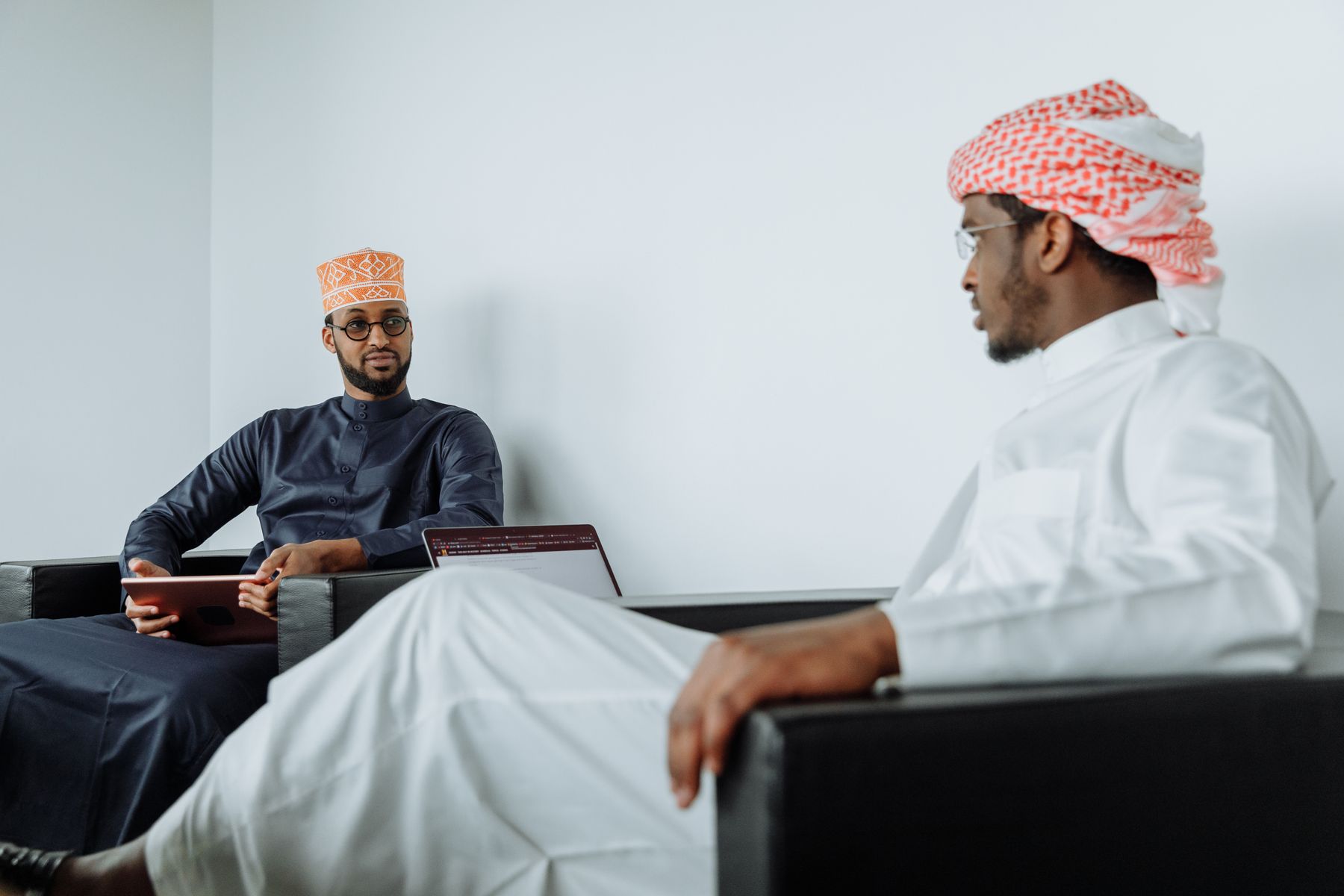 Two Muslim businessmen in a focused conversation